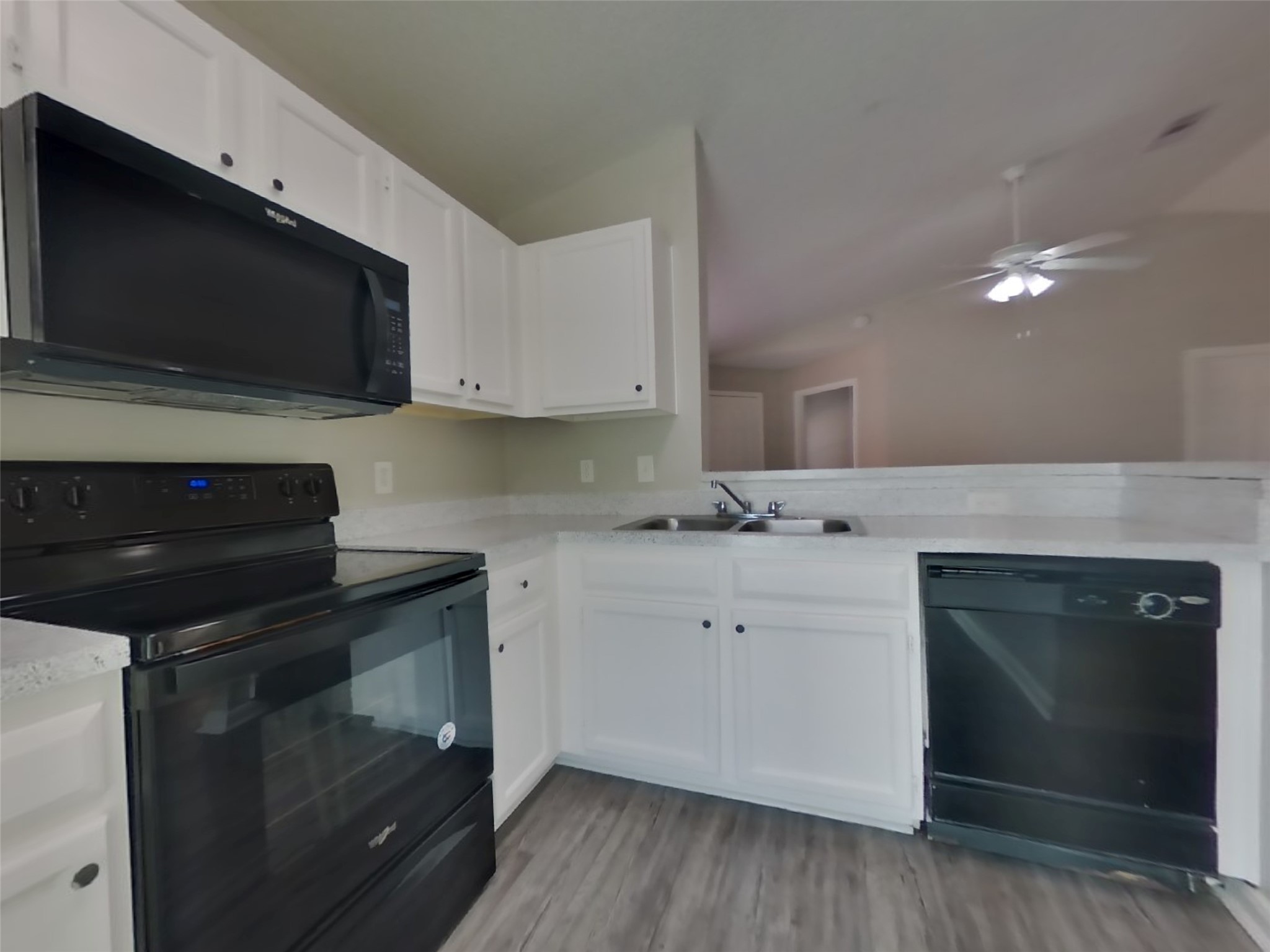 3131 Kelling Street Houston, TX 77045 - Photo 7 of 18 a kitchen with a stove and a microwave