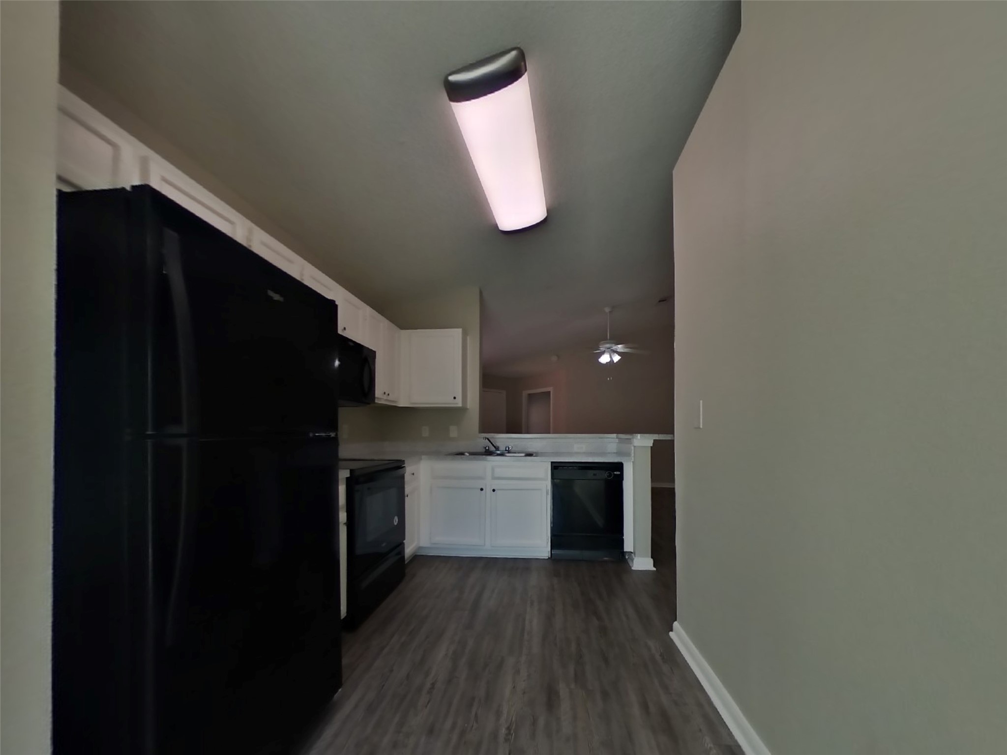 3131 Kelling Street Houston, TX 77045 - Photo 8 of 18 a kitchen with a refrigerator and a stove top oven