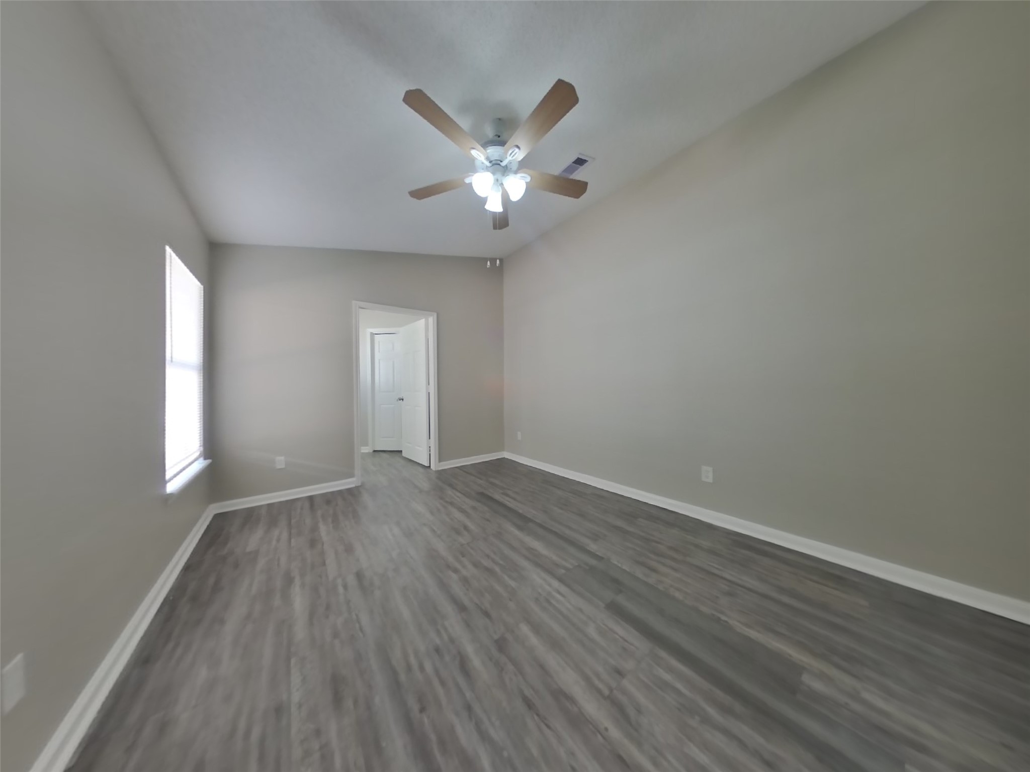 3131 Kelling Street Houston, TX 77045 - Photo 9 of 18 wooden floor in an empty room with a window