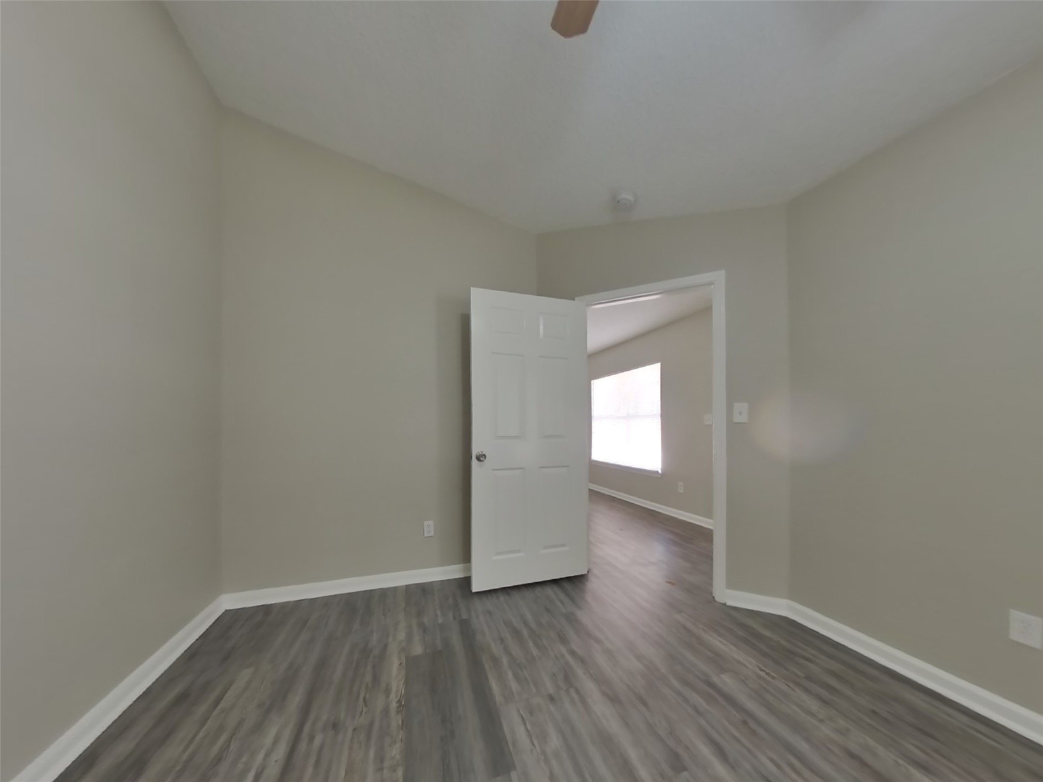 3131 Kelling Street Houston, TX 77045 - Photo 10 of 18 a view of an empty room with wooden floor and a window