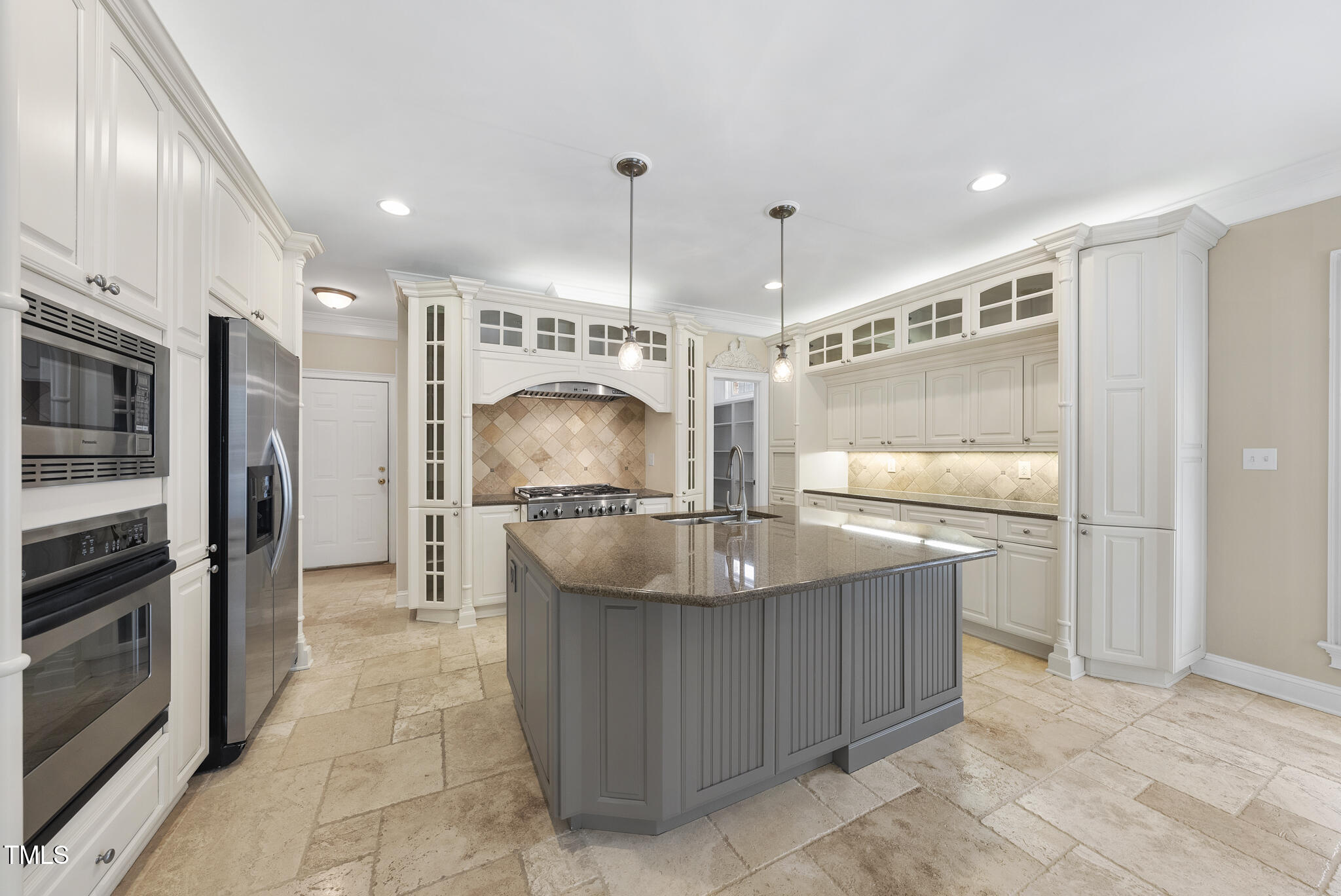 12257 Beestone Lane Raleigh, NC 27614 - Photo 10 of 59 a kitchen with stainless steel appliances granite countertop a sink and a refrigerator