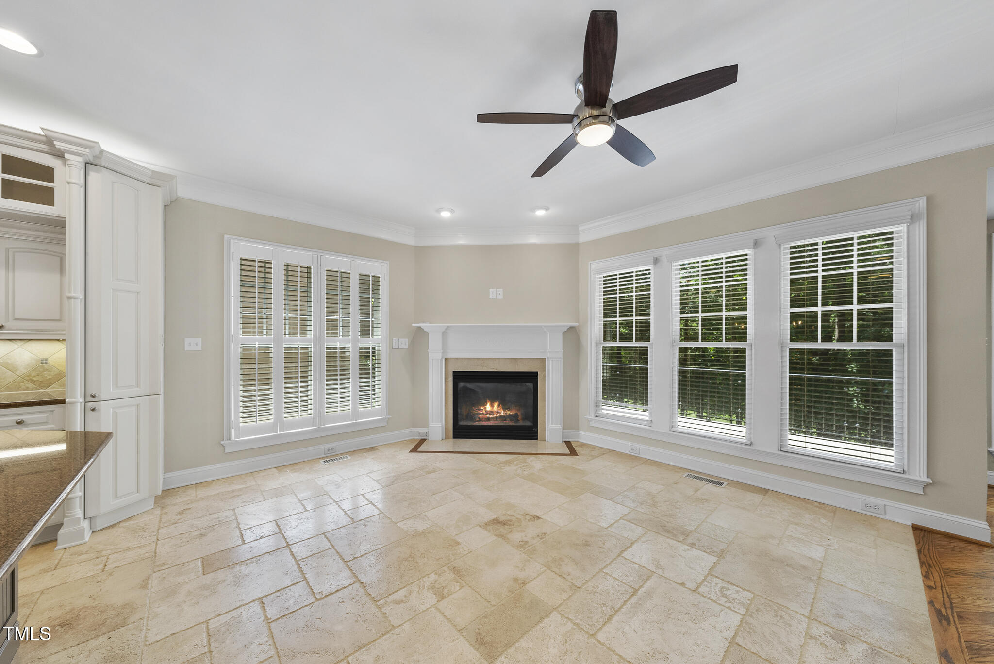 12257 Beestone Lane Raleigh, NC 27614 - Photo 13 of 59 a view of an empty room with a fireplace and a window