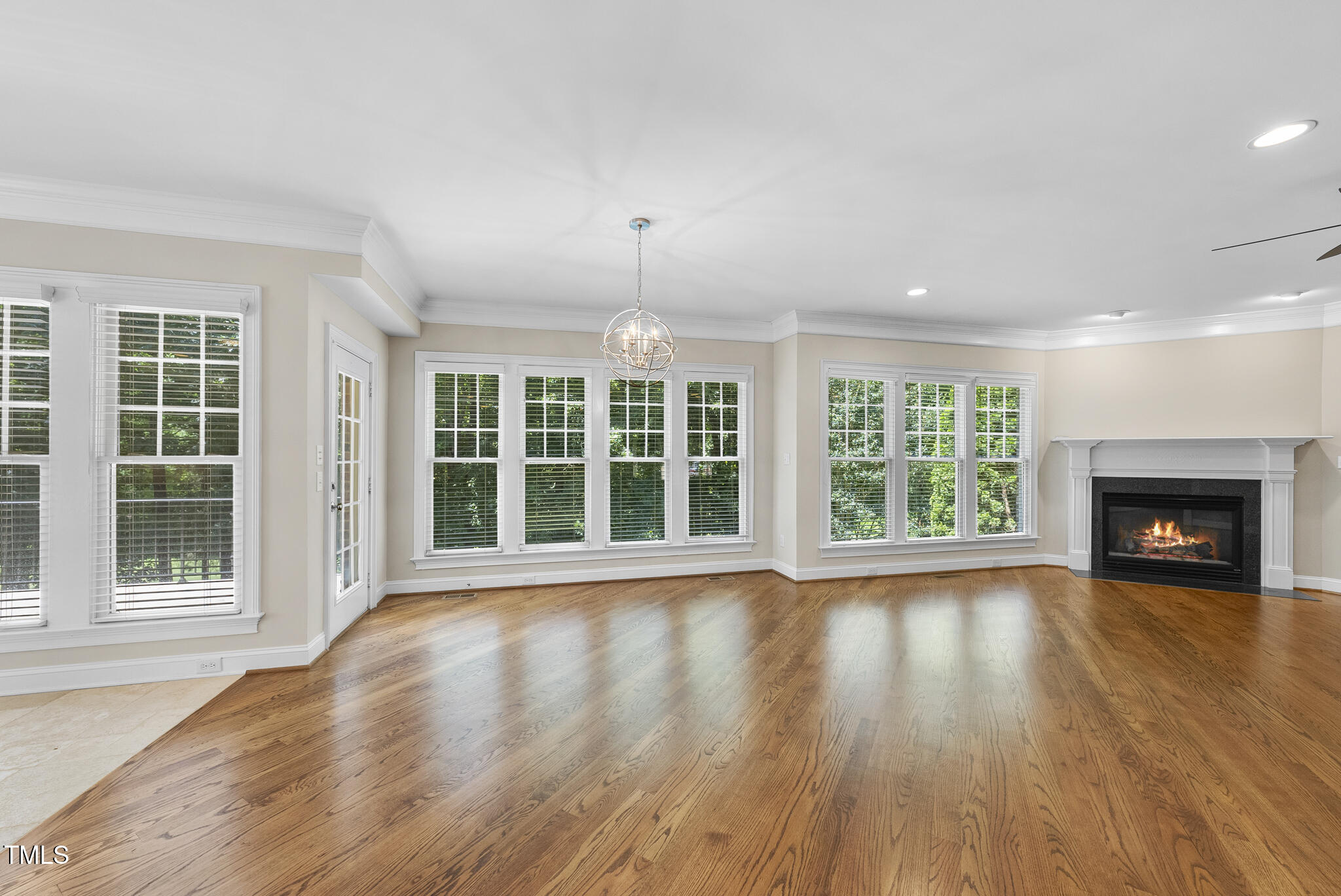 12257 Beestone Lane Raleigh, NC 27614 - Photo 16 of 59 a view of an empty room with wooden floor and a window