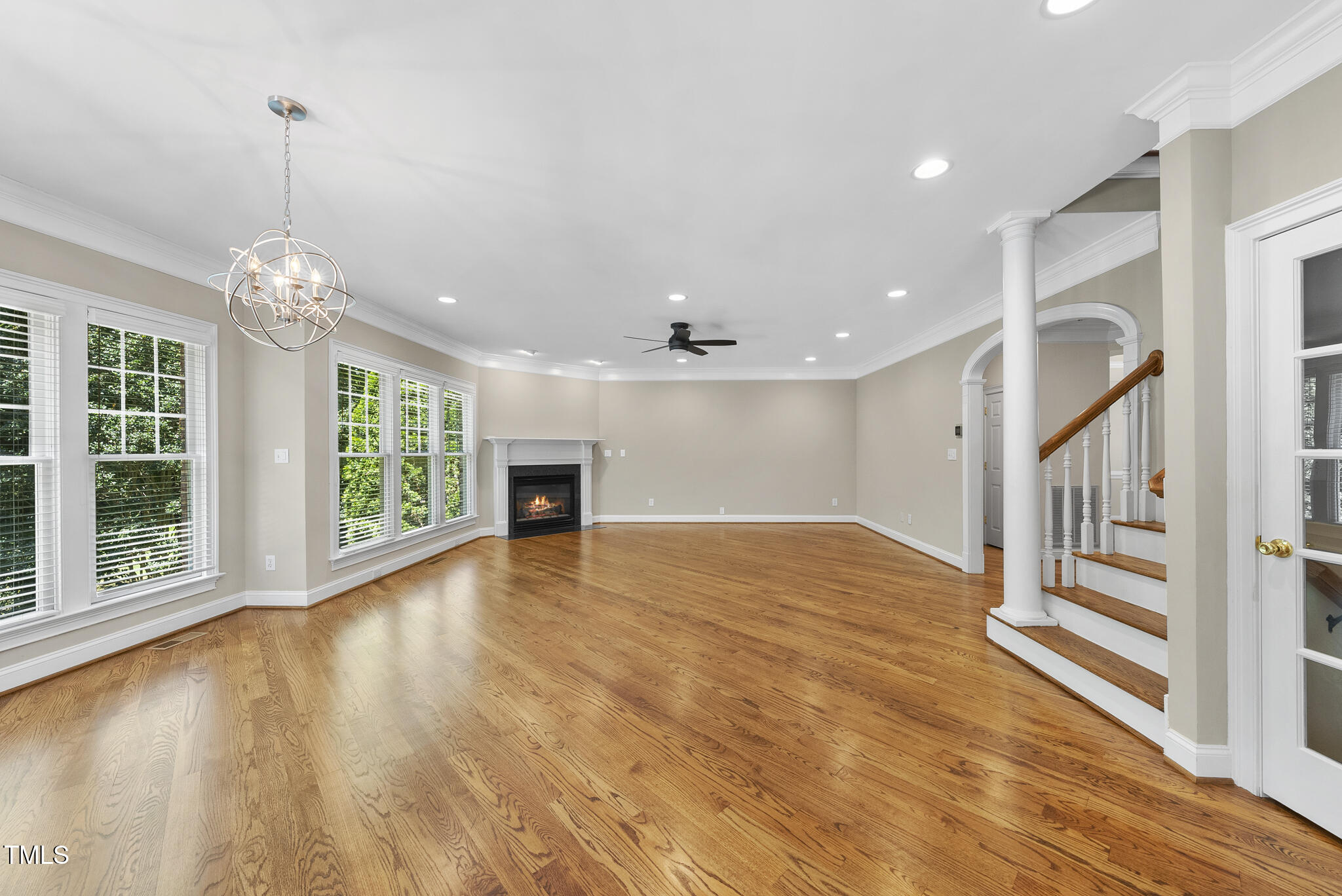 12257 Beestone Lane Raleigh, NC 27614 - Photo 17 of 59 a view of an empty room with a window and wooden floor