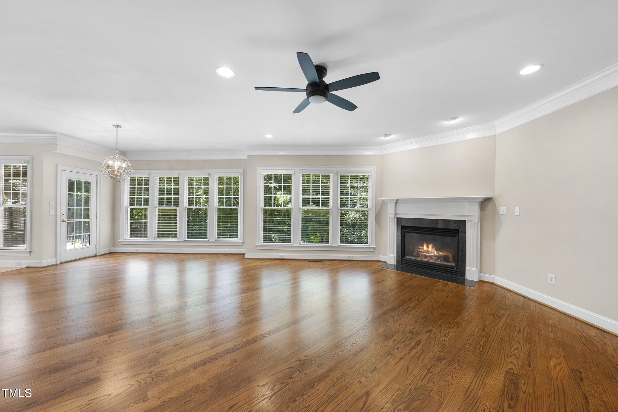 12257 Beestone Lane Raleigh, NC 27614 - Photo 18 of 59 a view of empty room with wooden floor and fireplace