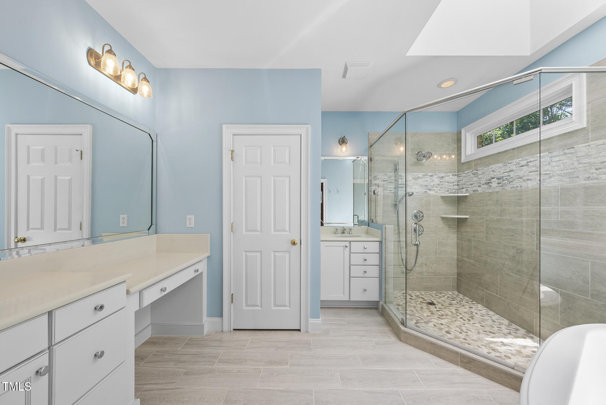12257 Beestone Lane Raleigh, NC 27614 - Photo 26 of 59 a bathroom with a shower sink and mirror