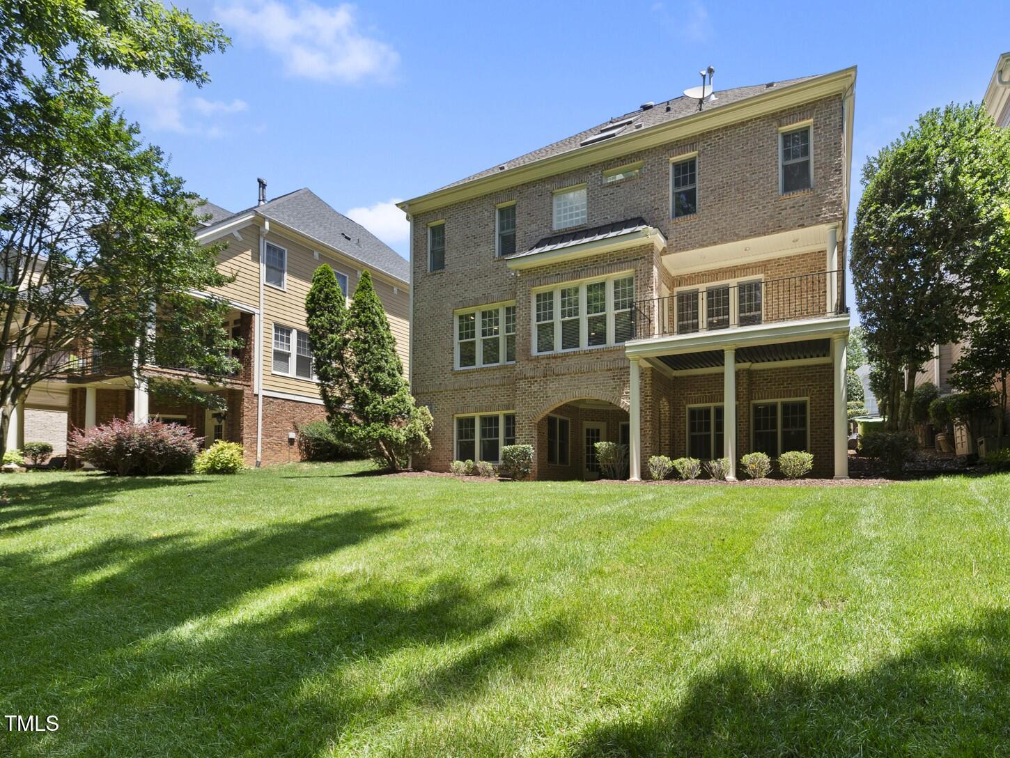 12257 Beestone Lane Raleigh, NC 27614 - Photo 54 of 59 a front view of a building with a garden