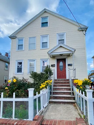 a front view of house with yard and glass windows