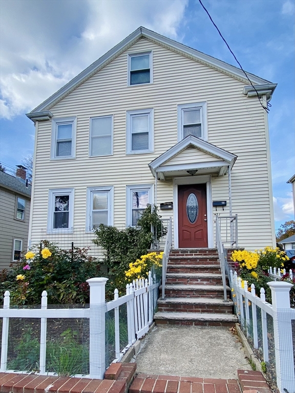 25 Elliot Street, Unit 25 Newton, MA 02461 - Photo 1 of 8 a front view of house with yard and glass windows