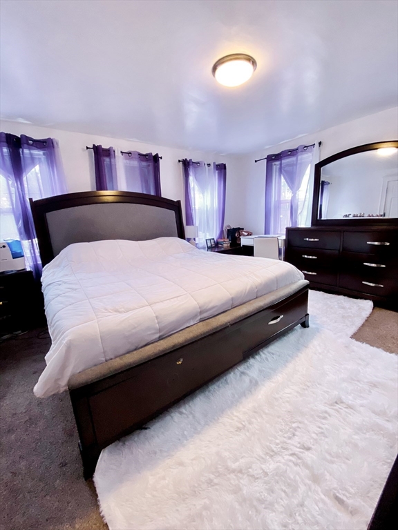 25 Elliot Street, Unit 25 Newton, MA 02461 - Photo 5 of 8 a bedroom with a bed and a lamp on dresser