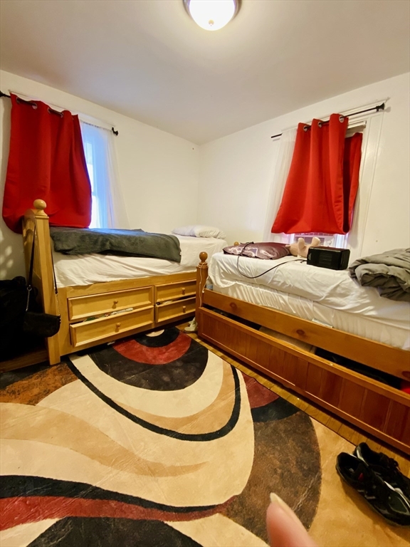 25 Elliot Street, Unit 25 Newton, MA 02461 - Photo 6 of 8 a room with a bed and a couch