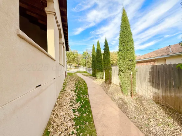 a living room with furniture fireplace and potted plants
