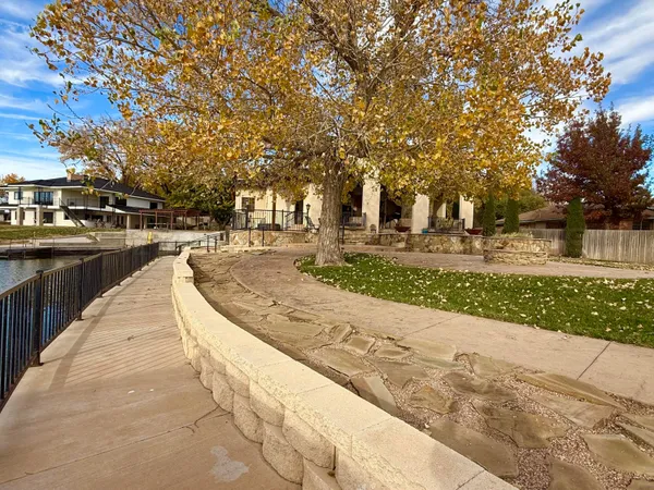 a living room with furniture a fireplace and a chandelier