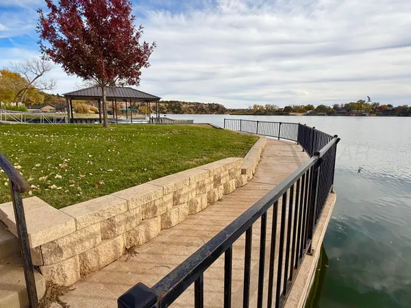 a living room with furniture a chandelier and a dining table