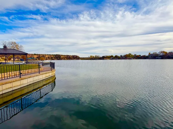 a kitchen with stainless steel appliances granite countertop a sink counter space cabinets and a wooden floor