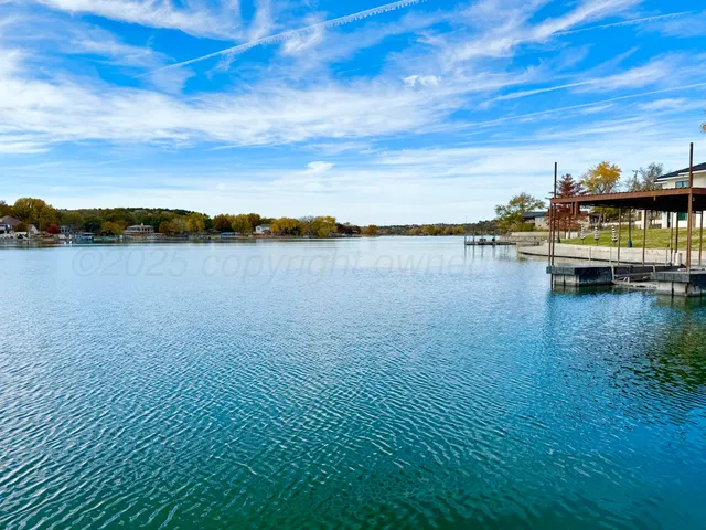 a kitchen with granite countertop a sink and a stove