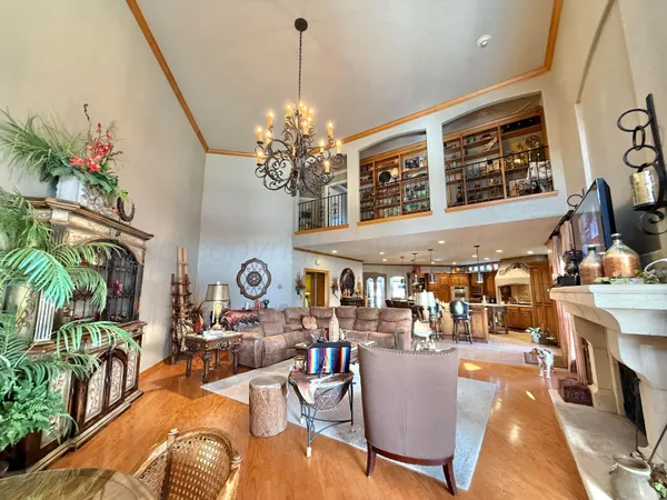 a spacious bedroom with a large bed and a chandelier