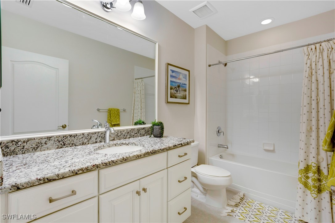 2343 Sheen Lane, Unit 401 Naples, FL 34120 - Photo 16 of 40 a bathroom with a granite countertop sink toilet and shower