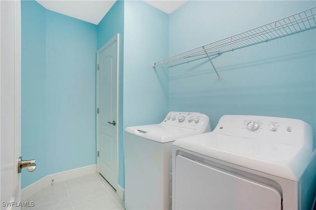 2343 Sheen Lane, Unit 401 Naples, FL 34120 - Photo 17 of 40 a utility room with dryer and washer