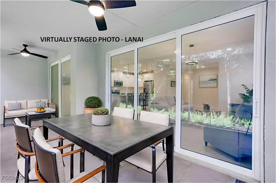 2343 Sheen Lane, Unit 401 Naples, FL 34120 - Photo 20 of 40 a kitchen with a table and chairs in it