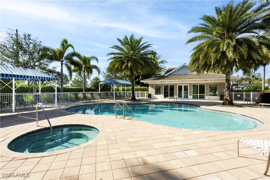 2343 Sheen Lane, Unit 401 Naples, FL 34120 - Photo 26 of 40 a swimming pool with outdoor seating and yard