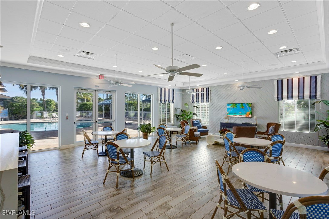 2343 Sheen Lane, Unit 401 Naples, FL 34120 - Photo 27 of 40 a view of a dining room with furniture window and wooden floor