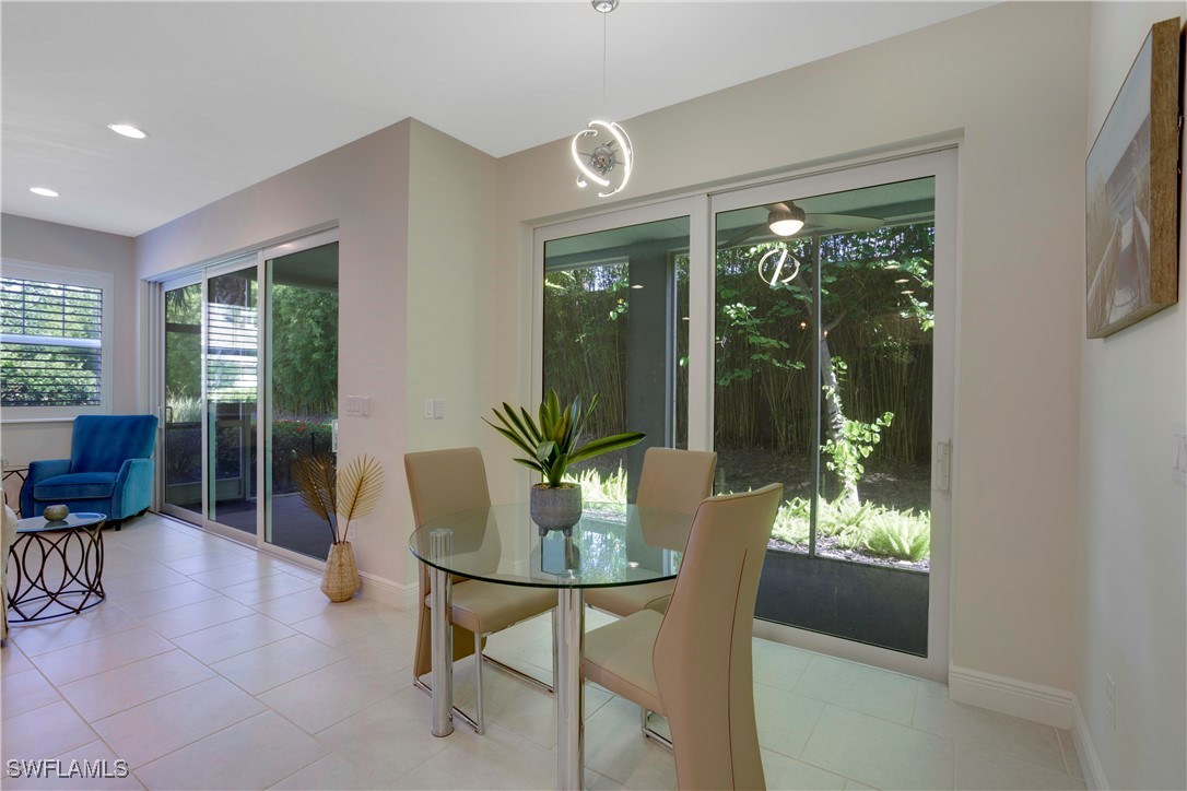 2343 Sheen Lane, Unit 401 Naples, FL 34120 - Photo 9 of 40 a dining room with furniture and large windows