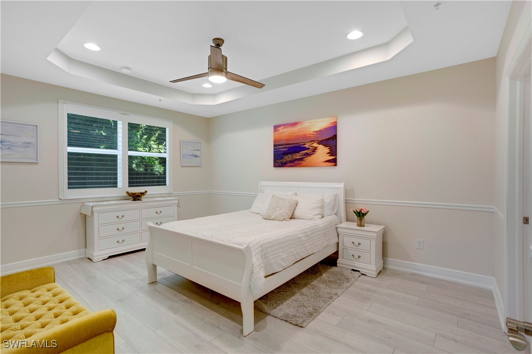 2343 Sheen Lane, Unit 401 Naples, FL 34120 - Photo 10 of 40 a bedroom with a bed and a couch