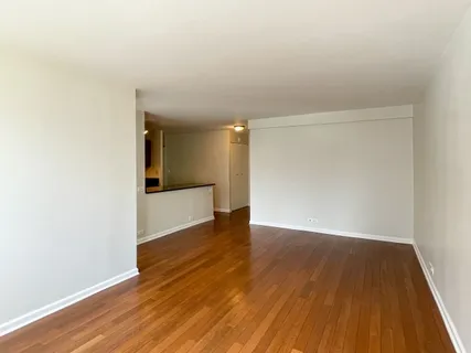 a view of a room with wooden floor and a window