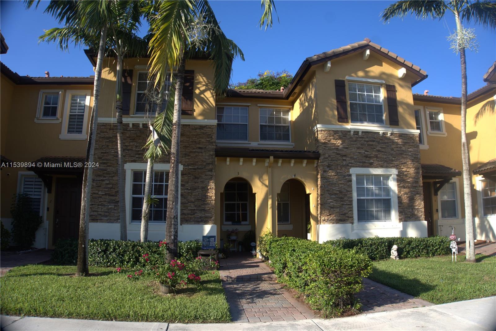 9143 Southwest 227th Street, Unit 3 Cutler Bay, FL 33190 - Photo 1 of 35 a front view of a house with a garden