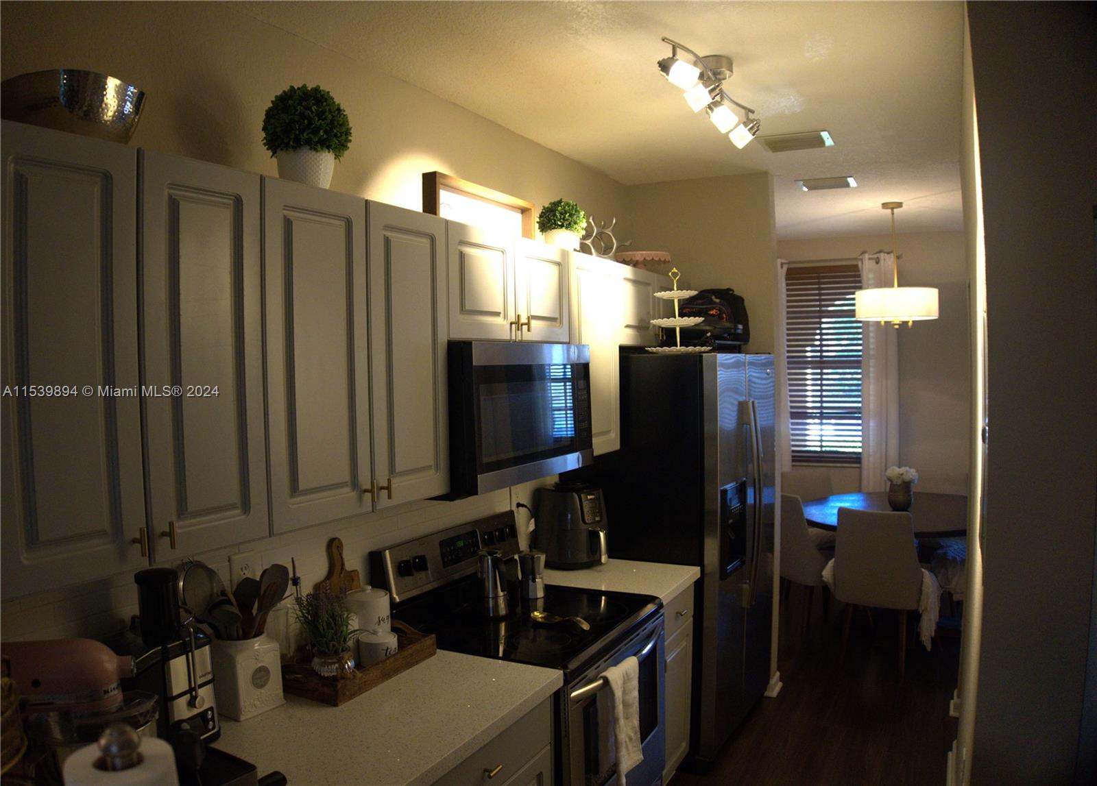 9143 Southwest 227th Street, Unit 3 Cutler Bay, FL 33190 - Photo 13 of 35 a kitchen with refrigerator and sink
