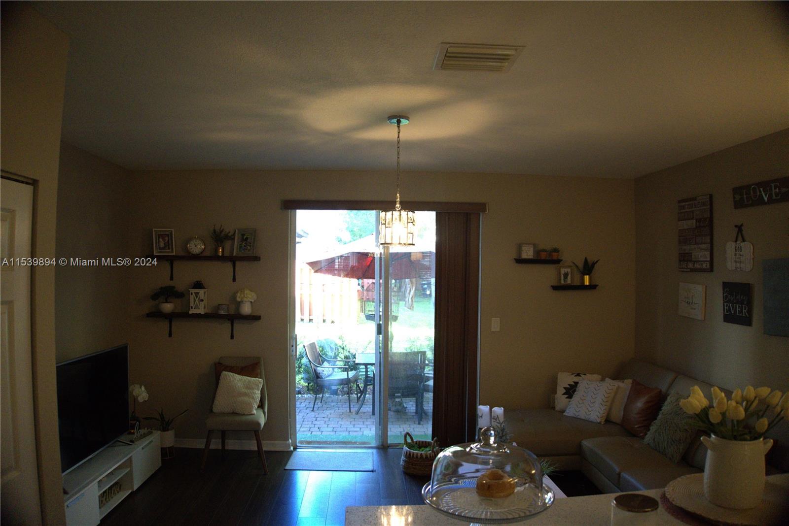 9143 Southwest 227th Street, Unit 3 Cutler Bay, FL 33190 - Photo 15 of 35 a living room with furniture and wooden floor
