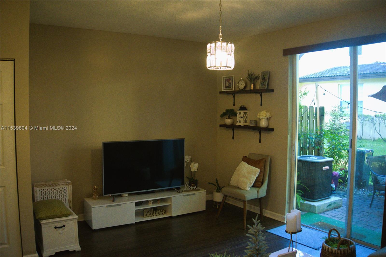 9143 Southwest 227th Street, Unit 3 Cutler Bay, FL 33190 - Photo 17 of 35 a view of a livingroom with furniture and a flat screen tv