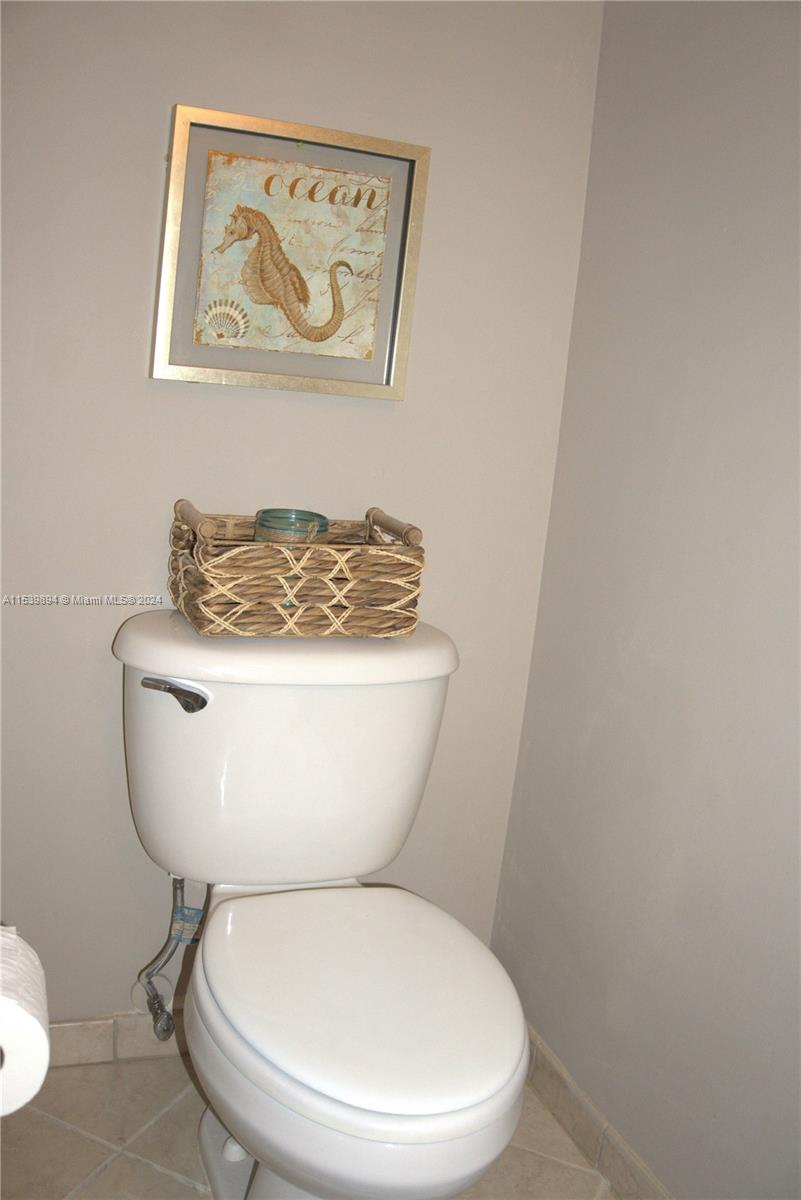 9143 Southwest 227th Street, Unit 3 Cutler Bay, FL 33190 - Photo 19 of 35 a white toilet sitting next to a white wall