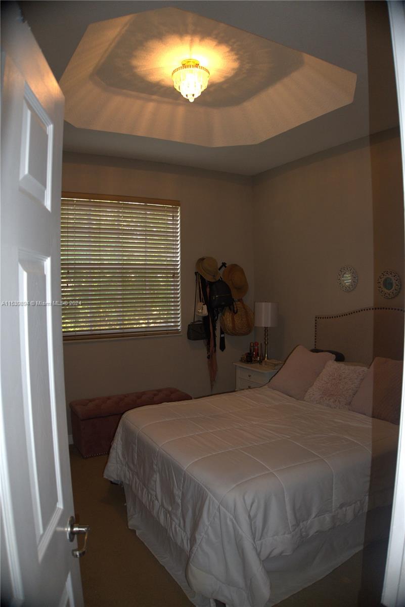 9143 Southwest 227th Street, Unit 3 Cutler Bay, FL 33190 - Photo 27 of 35 a bedroom with a bed and a window