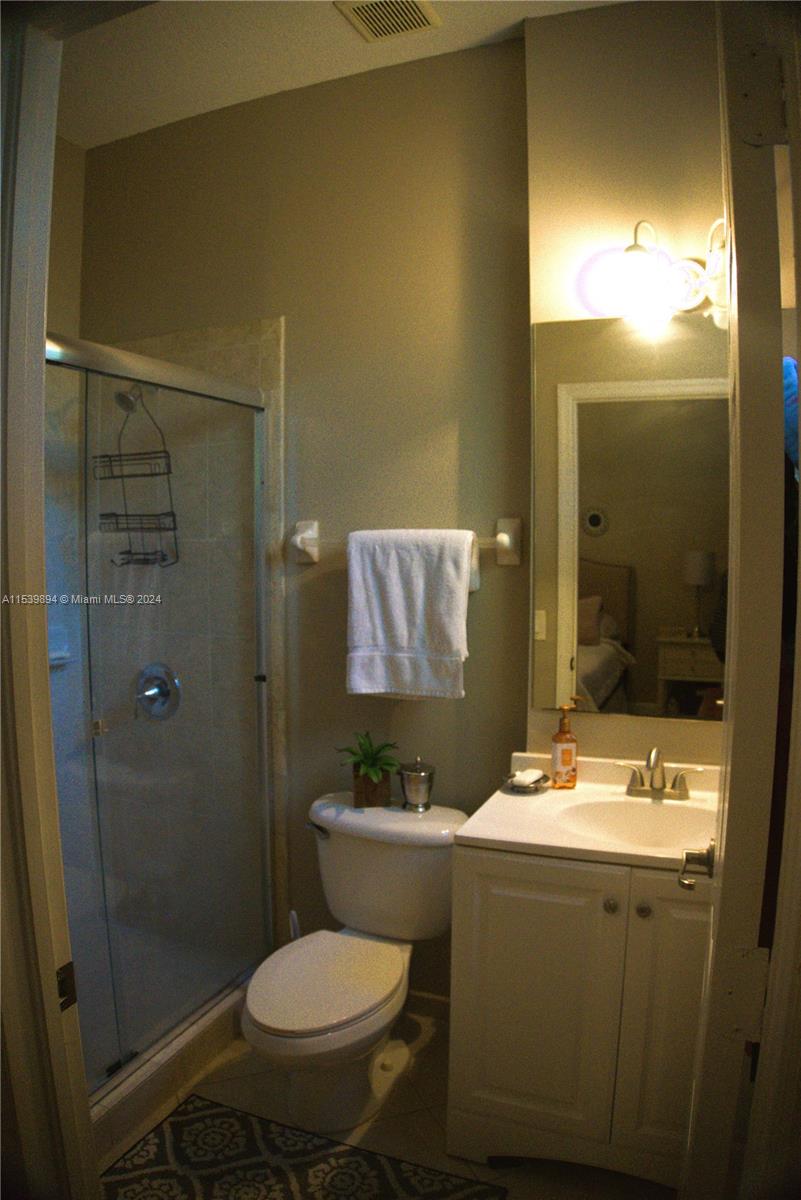 9143 Southwest 227th Street, Unit 3 Cutler Bay, FL 33190 - Photo 30 of 35 a bathroom with a sink toilet and shower