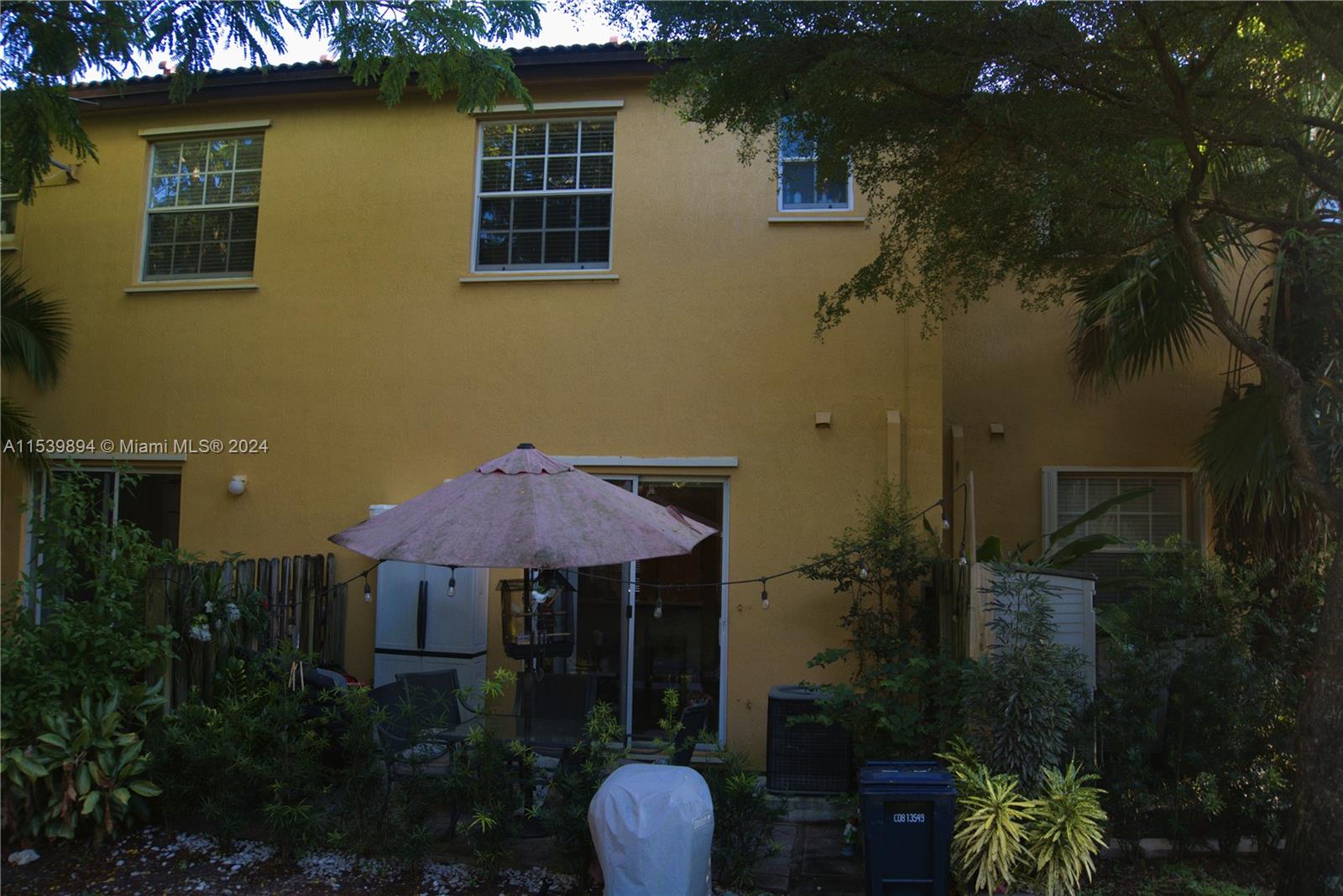 9143 Southwest 227th Street, Unit 3 Cutler Bay, FL 33190 - Photo 34 of 35 a front view of a house with a yard and garage