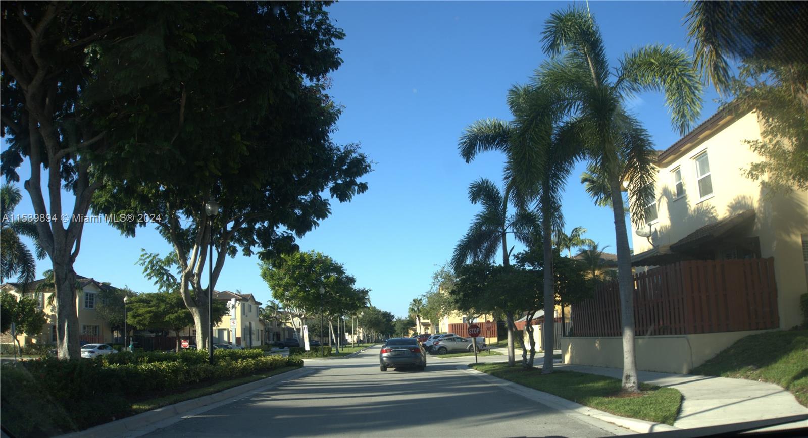 9143 Southwest 227th Street, Unit 3 Cutler Bay, FL 33190 - Photo 4 of 35 a view of street with parked cars
