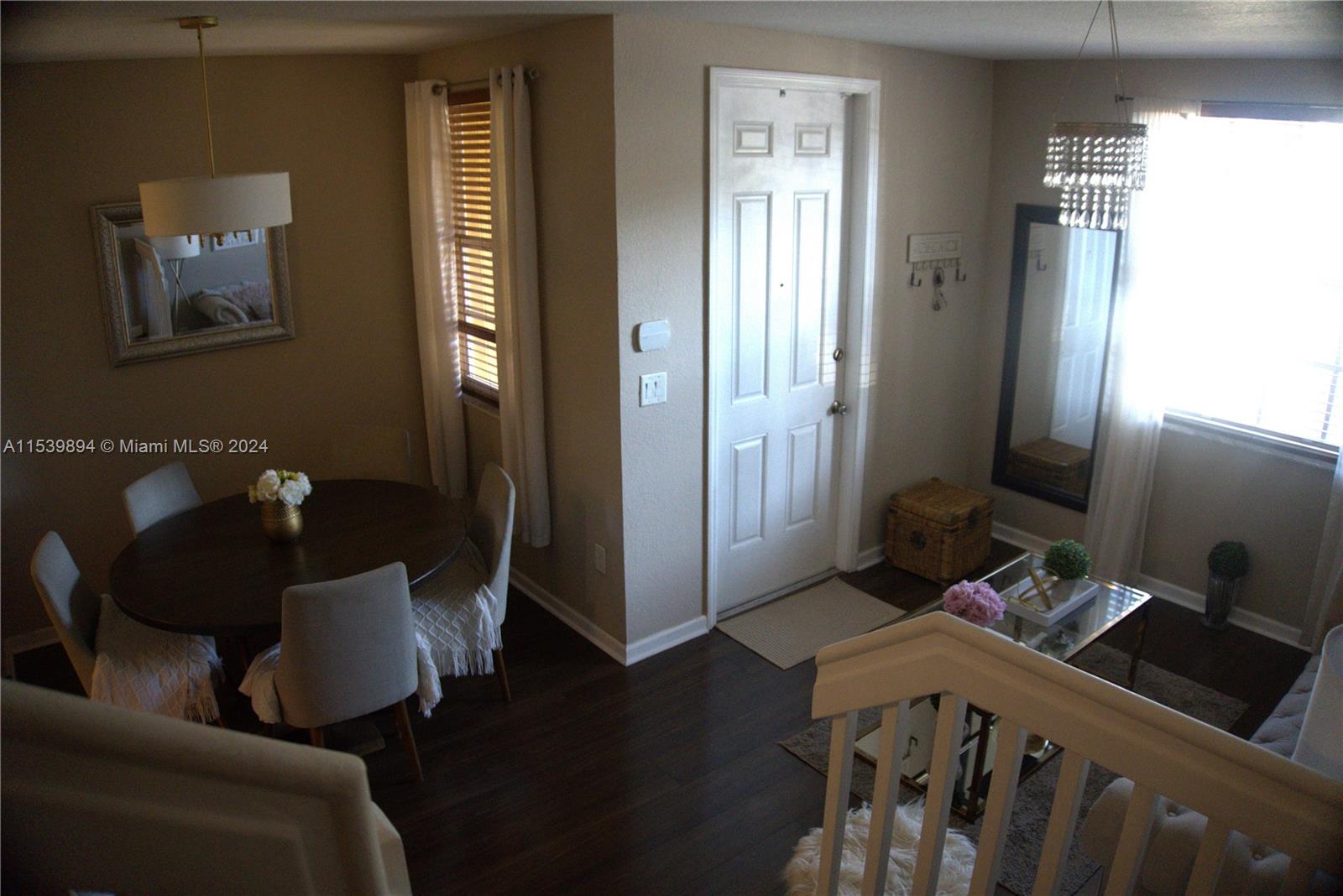9143 Southwest 227th Street, Unit 3 Cutler Bay, FL 33190 - Photo 6 of 35 a living room with furniture and a window