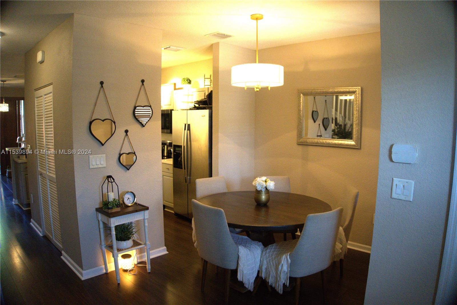 9143 Southwest 227th Street, Unit 3 Cutler Bay, FL 33190 - Photo 8 of 35 a view of a dining room with a table and chairs