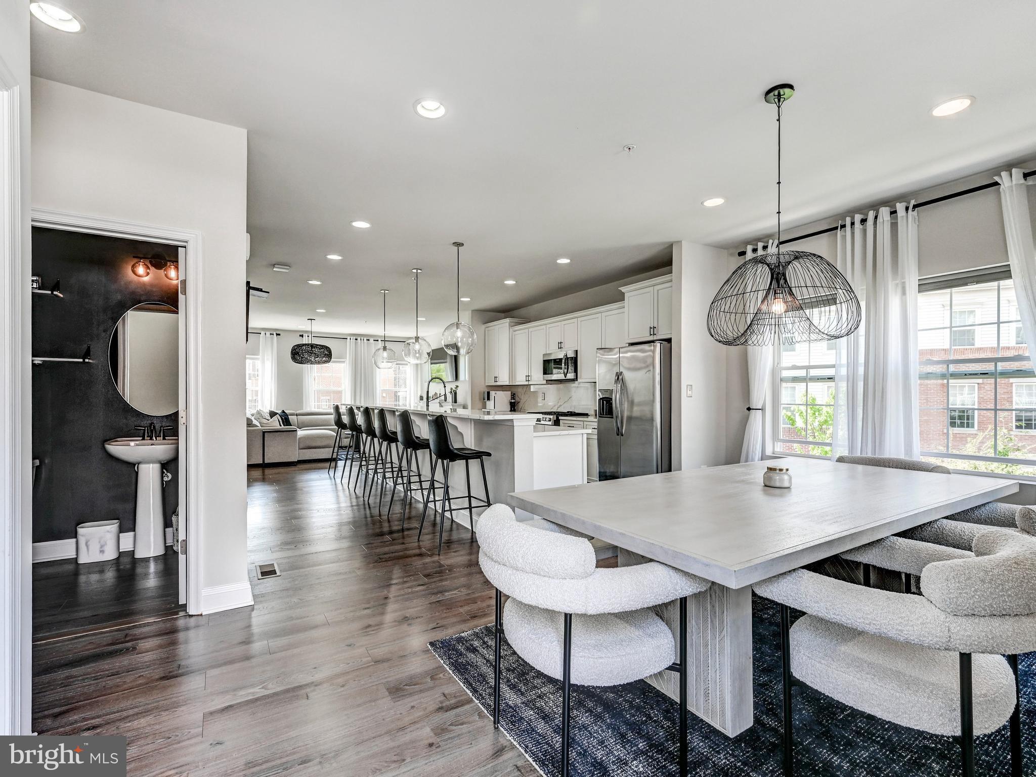 5000 John Buck Avenue Perry Hall, MD 21128 - Photo 20 of 41 a open kitchen with stainless steel appliances granite countertop a dining table chairs and stove