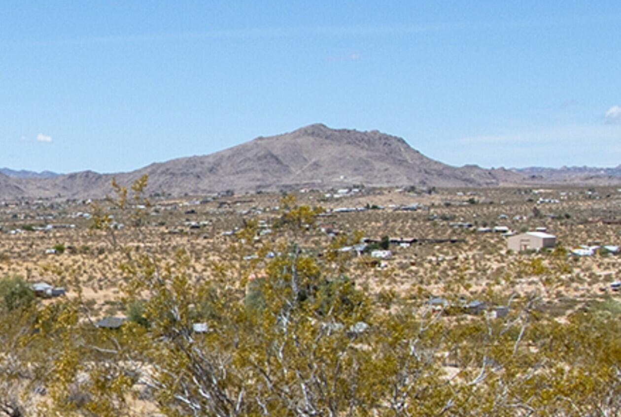 140 Rice Avenue Joshua Tree, CA 92252 - Photo 17 of 24 a view of a mountain range in a cloudy sky