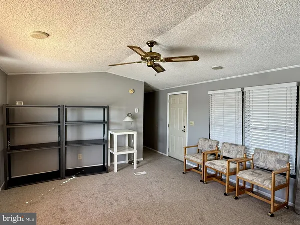 a view of a livingroom with a fireplace and a window