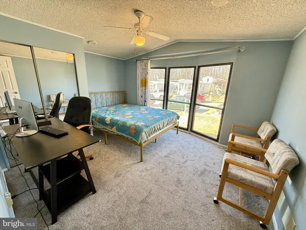 a bedroom with furniture and a window