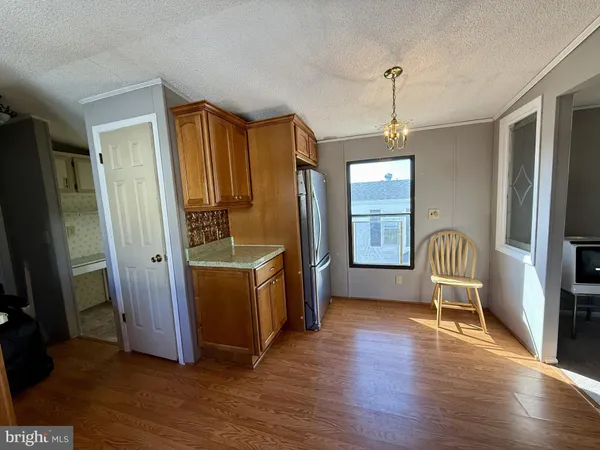 a view of kitchen with furniture wooden floor and window