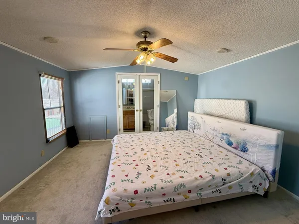 a bedroom with a bed and window