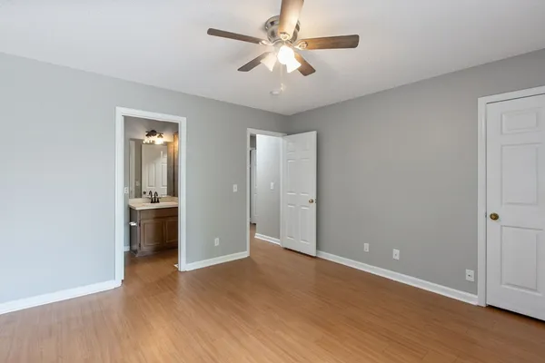 an empty room with cabinet and a ceiling fan