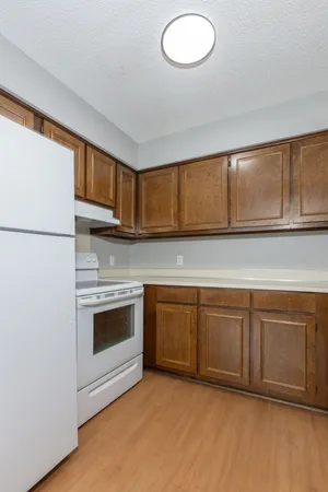 a kitchen with granite countertop cabinets stainless steel appliances and a sink