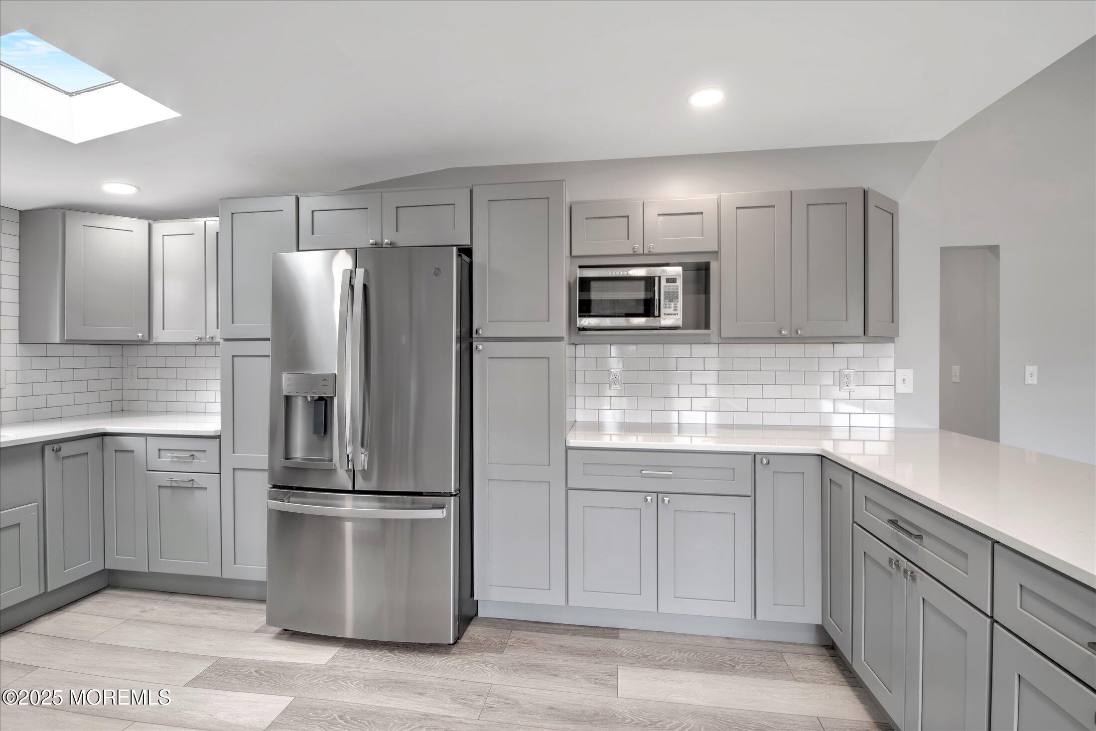 314 Motor Road Pine Beach, NJ 08741 - Photo 13 of 38 a kitchen with kitchen island a refrigerator sink and cabinets