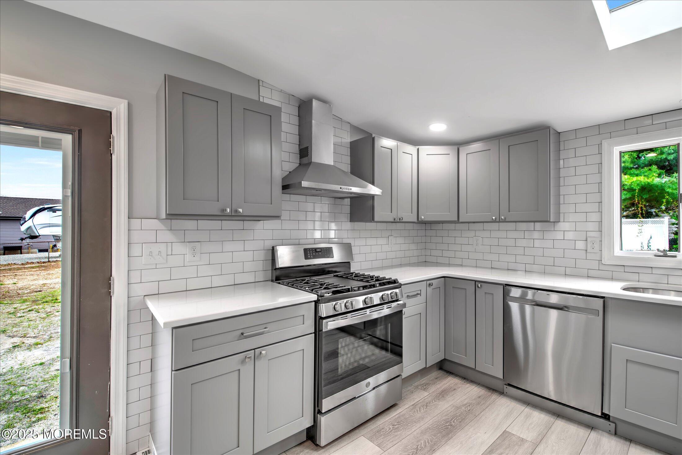 314 Motor Road Pine Beach, NJ 08741 - Photo 16 of 38 a kitchen with cabinets appliances and a window